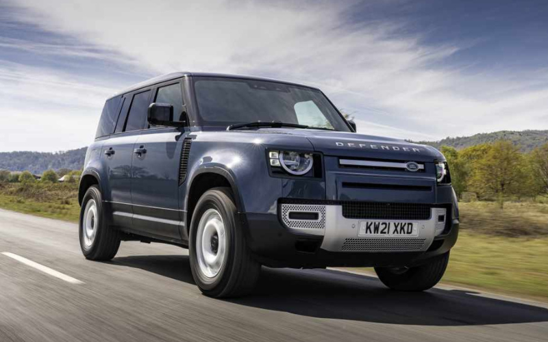 Land Rover Defender 4x4 driving along a country road