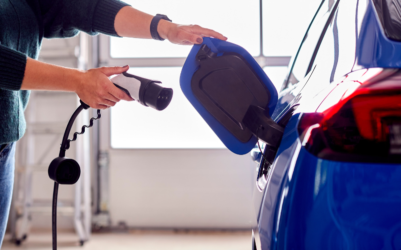 Person about to plug in their electric car to recharge