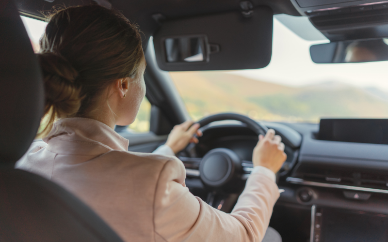 Woman concentrating on driving electric vehicle responsibly