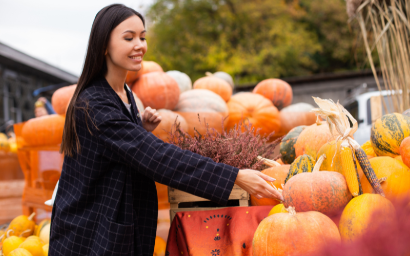 Woman picking pumpkins at a farm